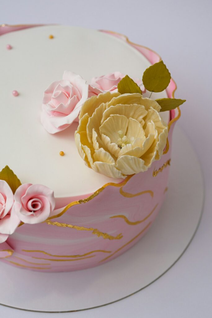 Vertical photo of floral cake design on a white background